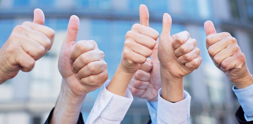 Businesspeople thumbs up